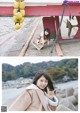 A woman posing for a picture in front of a boat.