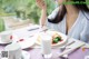 A woman sitting at a table with a plate of food.