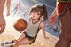 A girl dribbling a basketball on a basketball court.