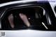 A person's feet sticking out the window of a car.