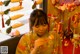 A woman in a kimono sitting at a table with a bunch of stuffed animals.