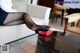 A woman sitting on a couch with her feet up on a coffee table.